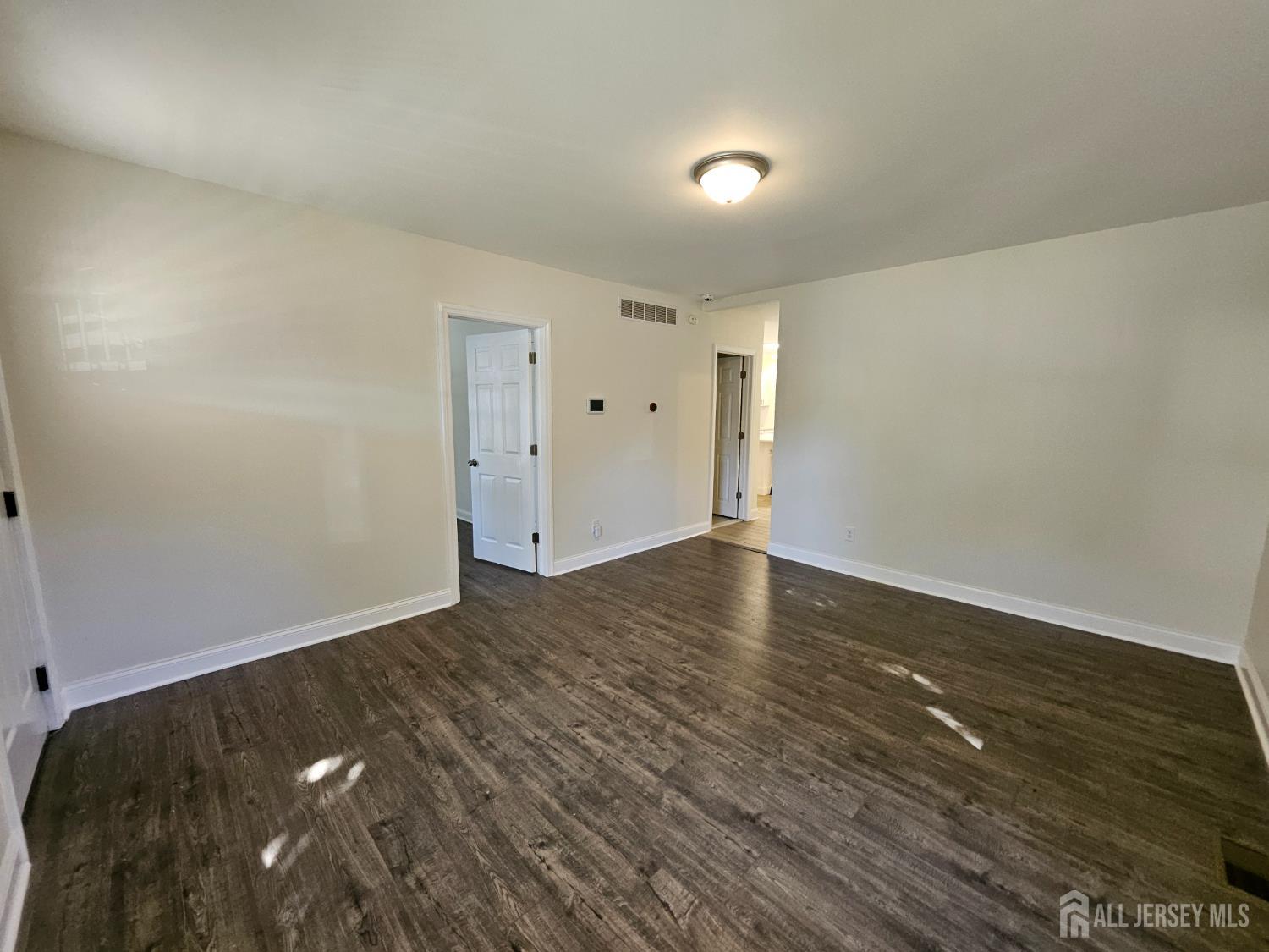 60 6th Avenue Trenton, NJ 08619 - Photo 24 of 28 a view of an empty room and wooden floor