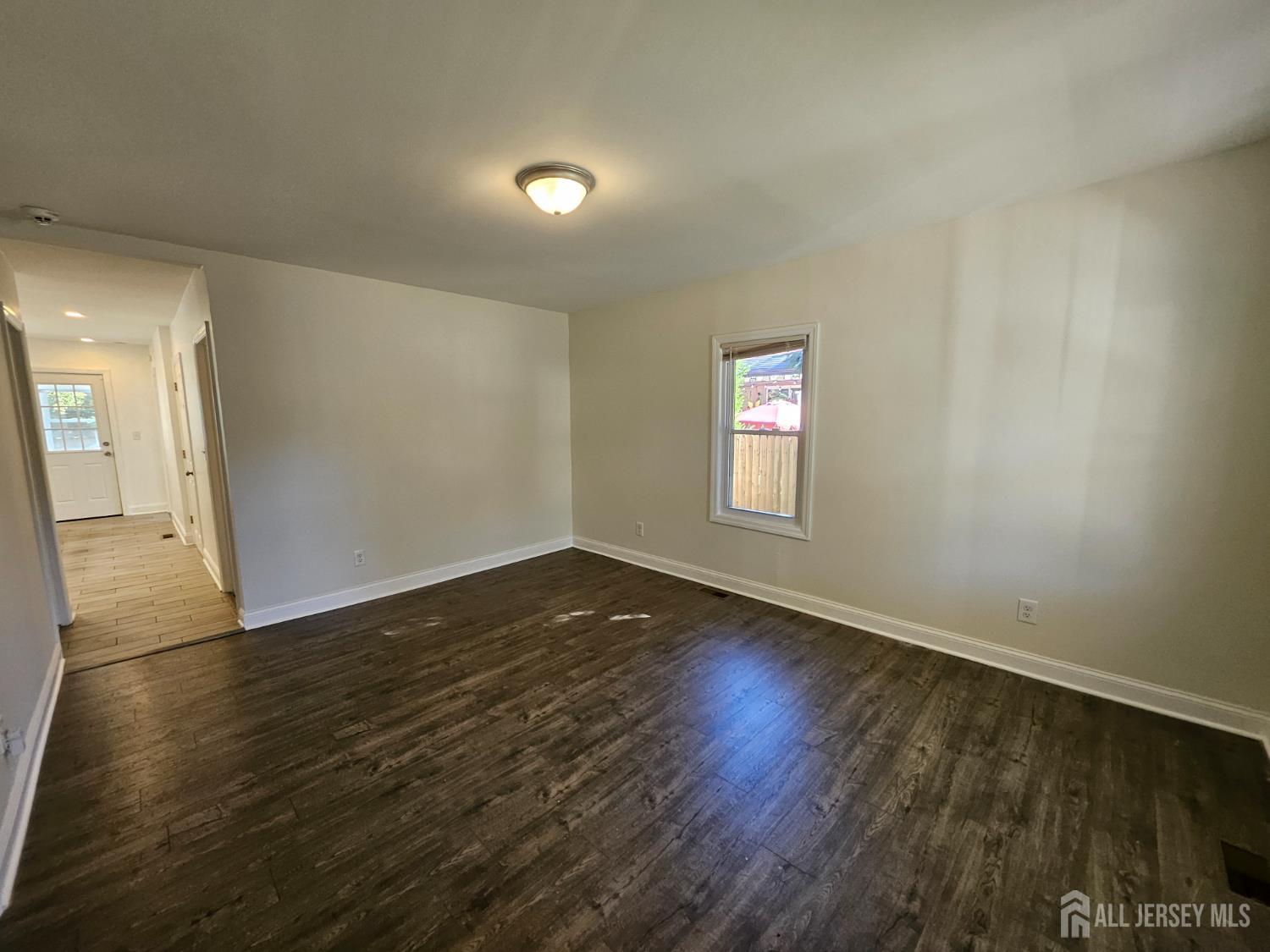 60 6th Avenue Trenton, NJ 08619 - Photo 25 of 28 an empty room with wooden floor and windows