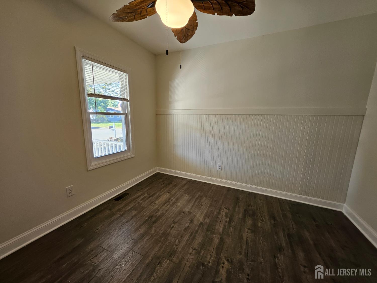 60 6th Avenue Trenton, NJ 08619 - Photo 9 of 28 an empty room with wooden floor and windows