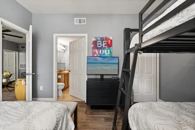 a bedroom with a bed and wooden floor