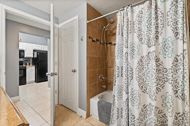 a bathroom with a shower and a mirror