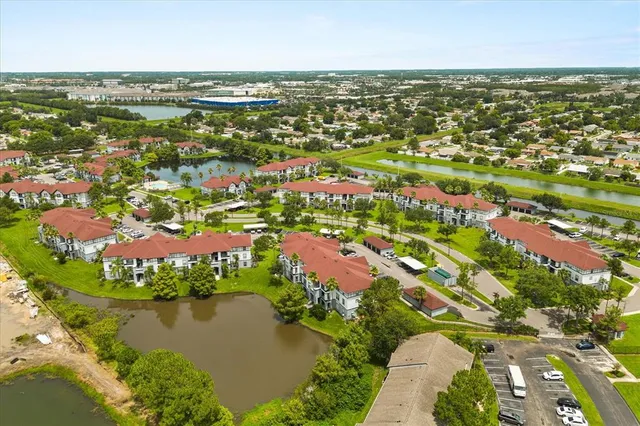 an aerial view of residential houses with outdoor space and river