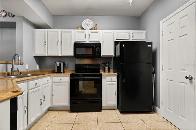 a kitchen with a refrigerator stove and sink