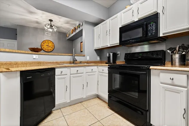 a kitchen with stainless steel appliances granite countertop a stove microwave and sink