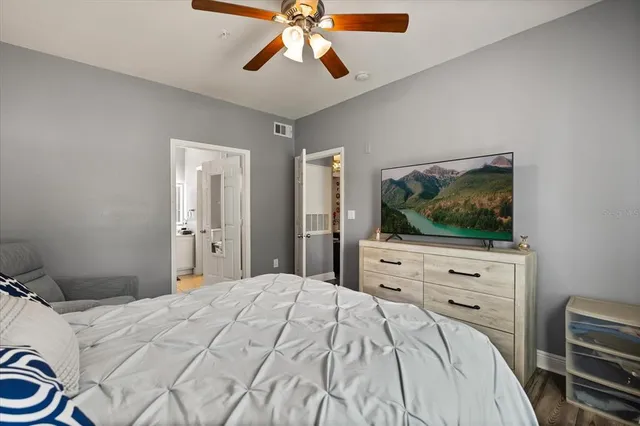 a bedroom with a bed and a flat screen tv