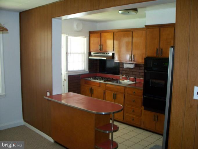 2234 Coralthorn Road Baltimore, MD 21220 - Photo 11 of 30 a kitchen with a window a sink and a refrigerator