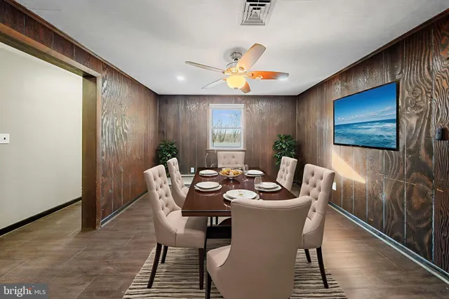 a dining room with furniture a rug and wooden floor