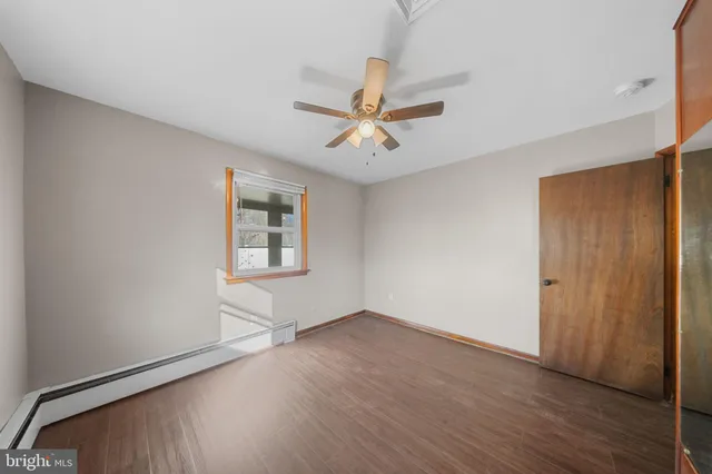 an empty room with wooden floor