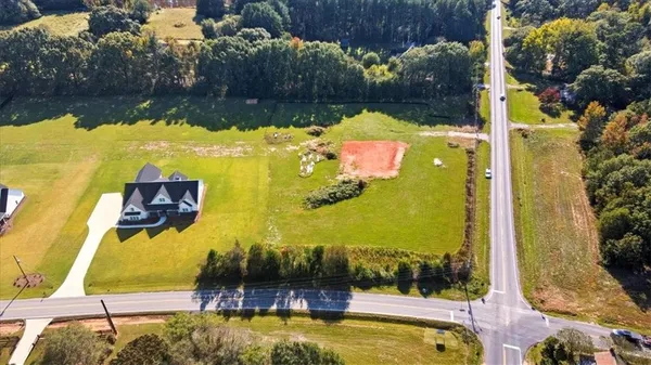 a view of a swimming pool with a yard and plants