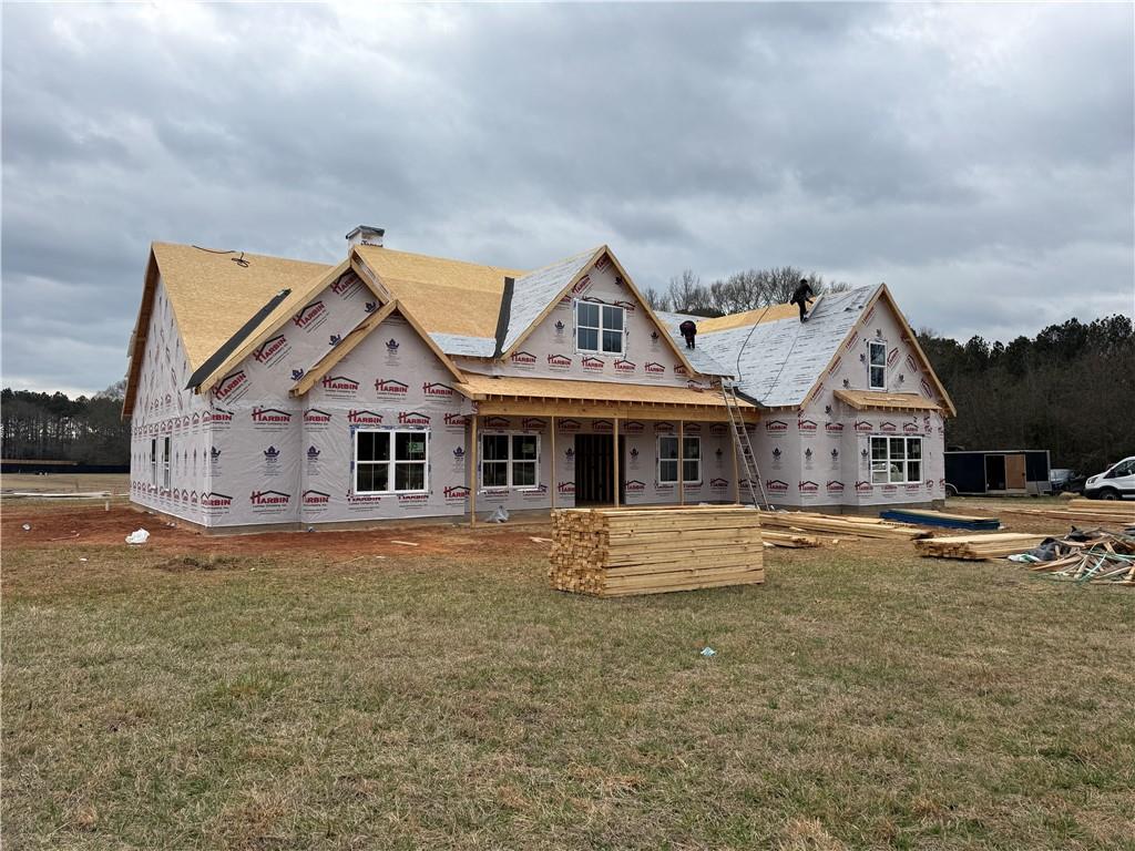 1217 Pleasant Valley Road Monroe, GA 30655 - Photo 3 of 8 a front view of a house with a garden and yard