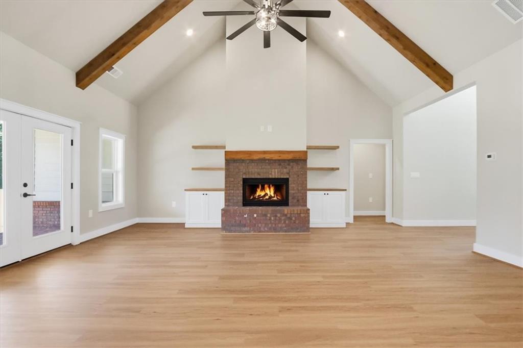1217 Pleasant Valley Road Monroe, GA 30655 - Photo 6 of 8 a view of an empty room with a fireplace and a window