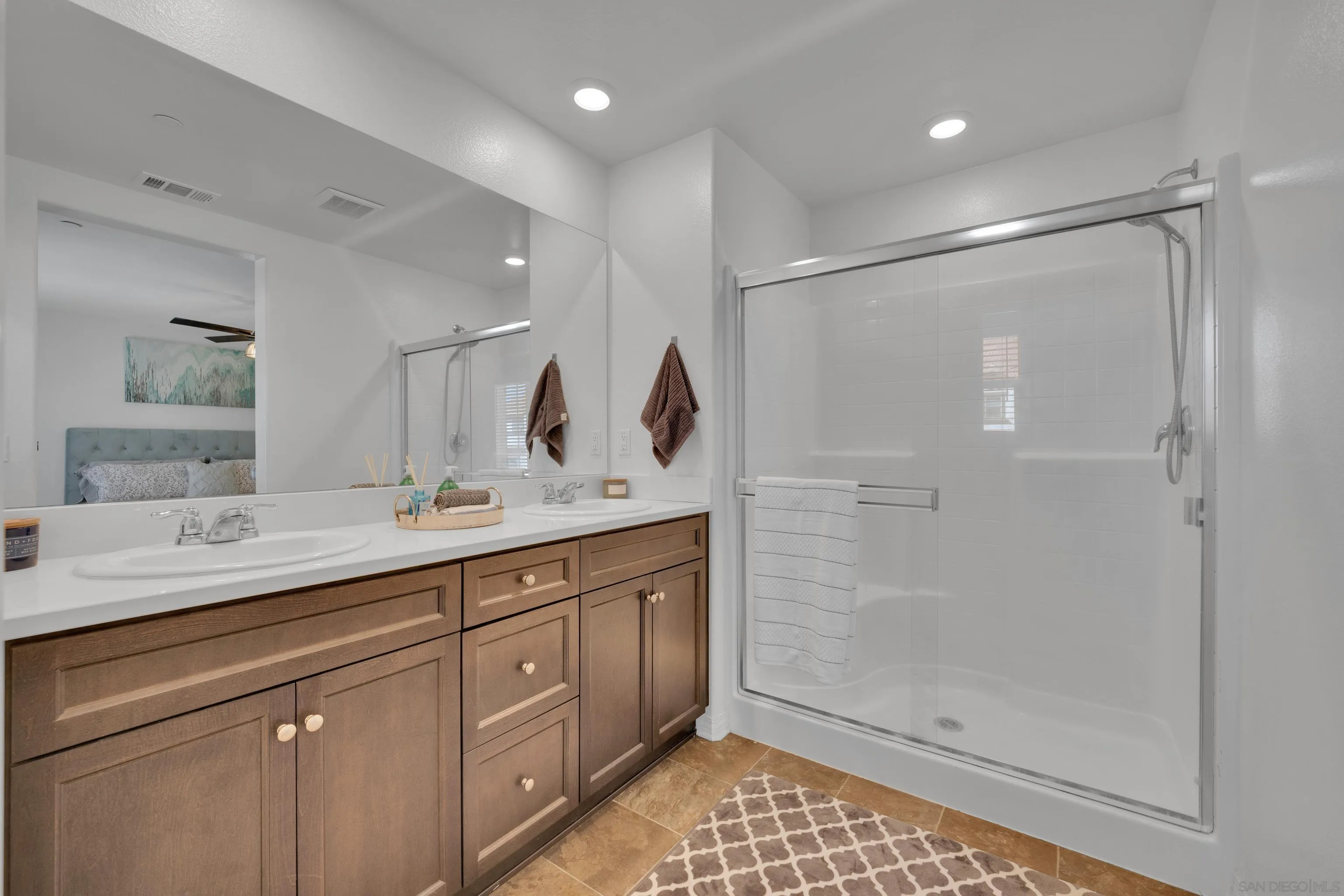 41984 Retsina Street, Unit 705 Murrieta, CA 92562 - Photo 19 of 39 a spacious bathroom with a shower sink and mirror