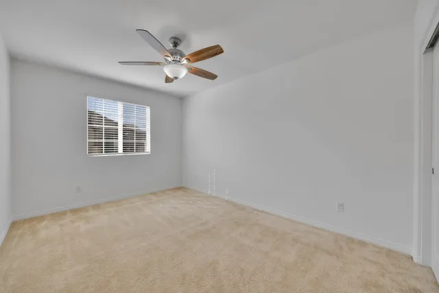 a spacious bathroom with a double vanity sink a toilet and a shower