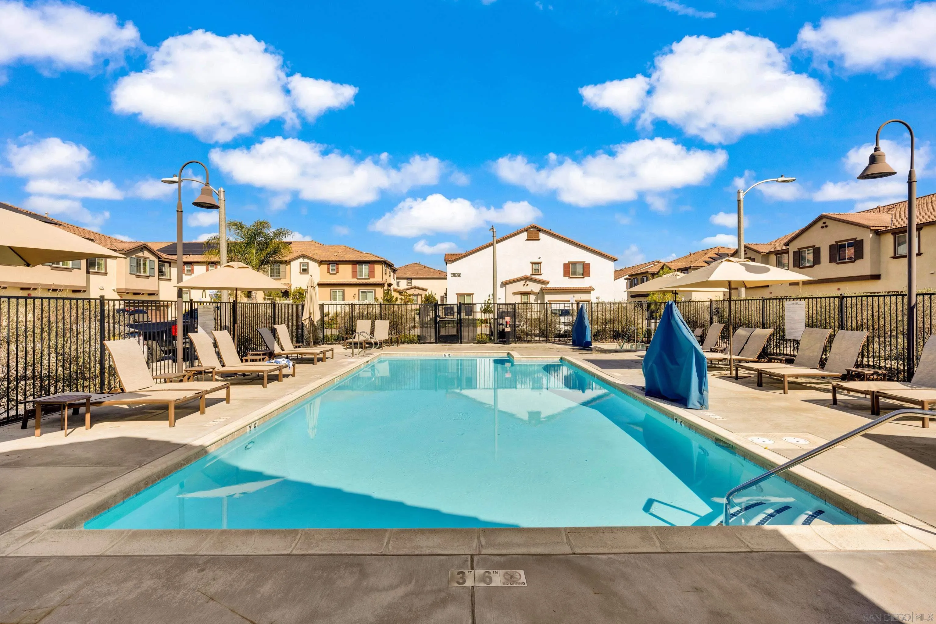 41984 Retsina Street, Unit 705 Murrieta, CA 92562 - Photo 34 of 39 a view of a swimming pool with a lounge chairs