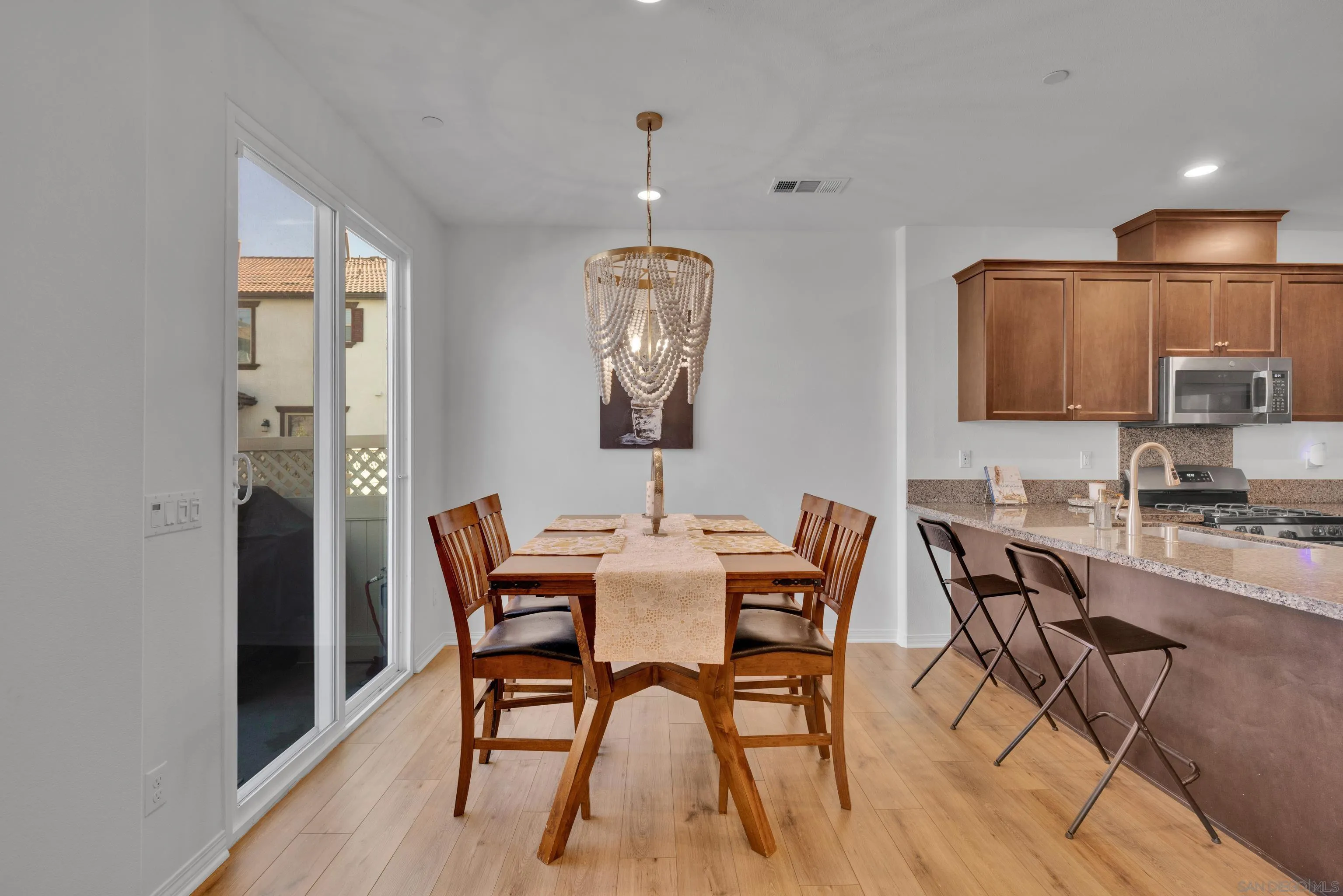 41984 Retsina Street, Unit 705 Murrieta, CA 92562 - Photo 6 of 39 a view of a dining room with furniture and wooden floor