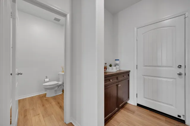 a bathroom with a sink a toilet and mirror