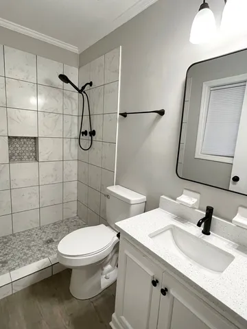 a bathroom with a toilet sink and shower