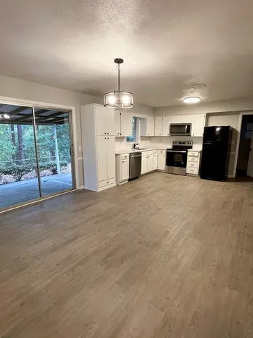 a view of a kitchen with a sink and dishwasher cabinets