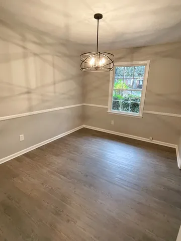 a view of a room with blue walls a ceiling fan and windows