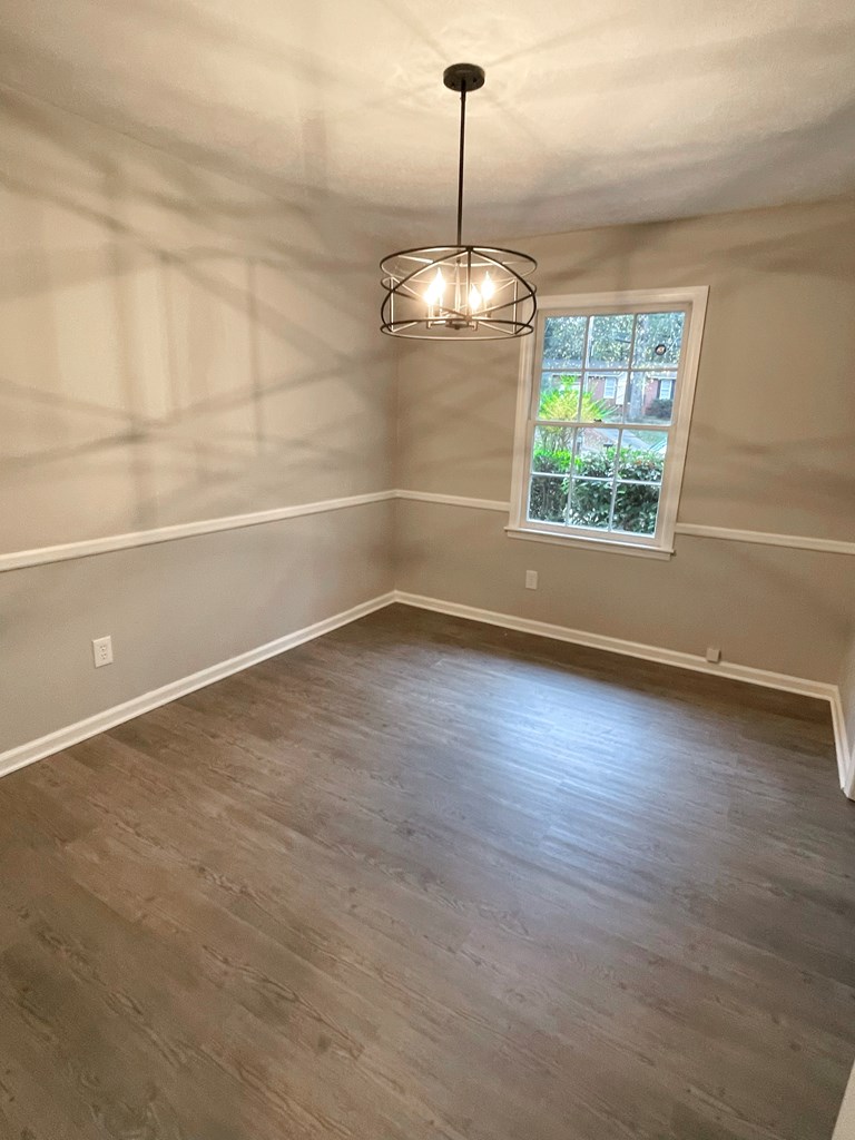5 Randall Court Columbus, GA 31909 - Photo 6 of 18 a view of a room with blue walls a ceiling fan and windows