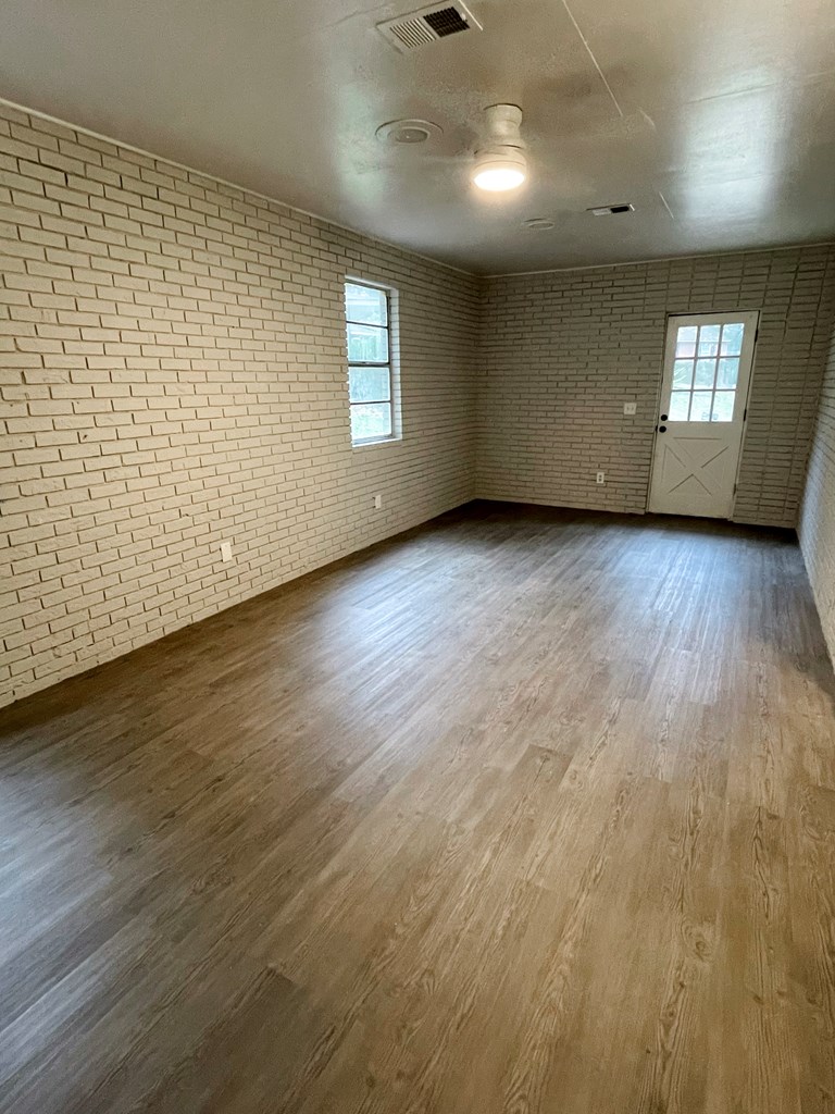 5 Randall Court Columbus, GA 31909 - Photo 7 of 18 an empty room with wooden floor and windows