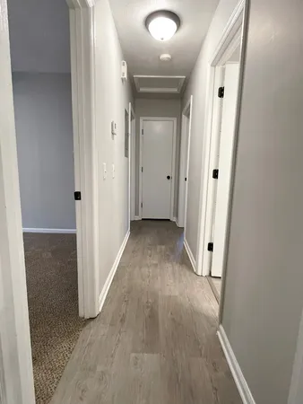 a view of a hallway with wooden floor