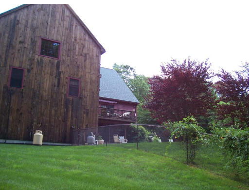 83 Wheelock Road Sutton, MA 01590 - Photo 21 of 24 a backyard of a house with lots of green space