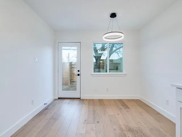 a kitchen with stainless steel appliances white cabinets and a stove top oven