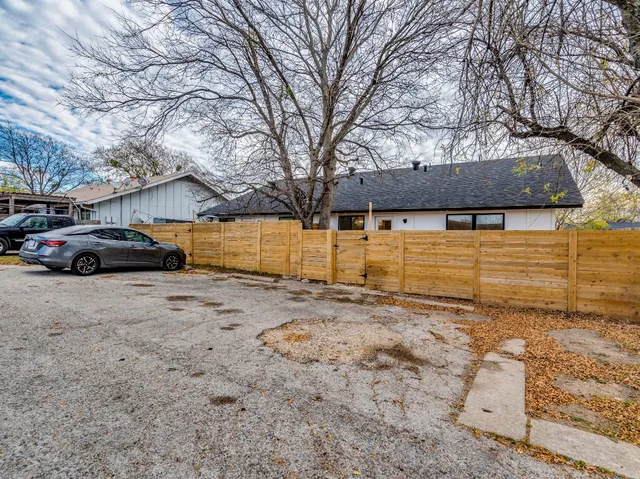 a front view of a house with parking yard and garage