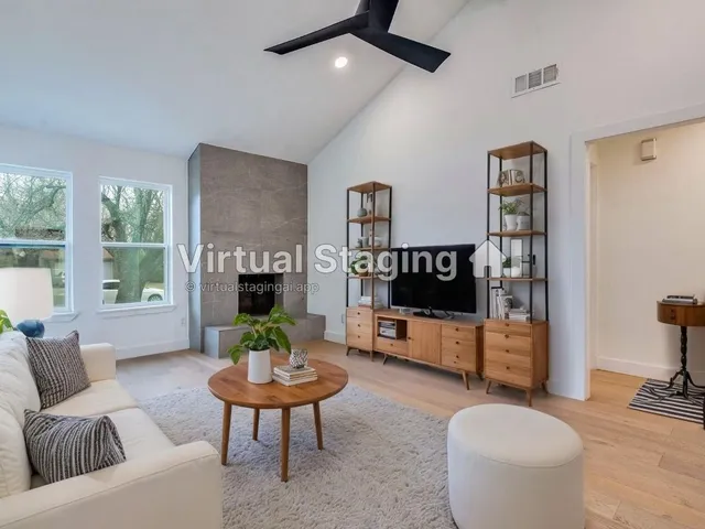 wooden floor fireplace and windows in an empty room
