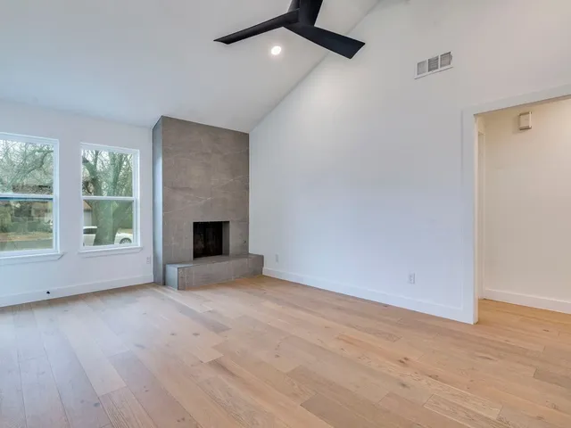 a living room with furniture a window and a flat screen tv
