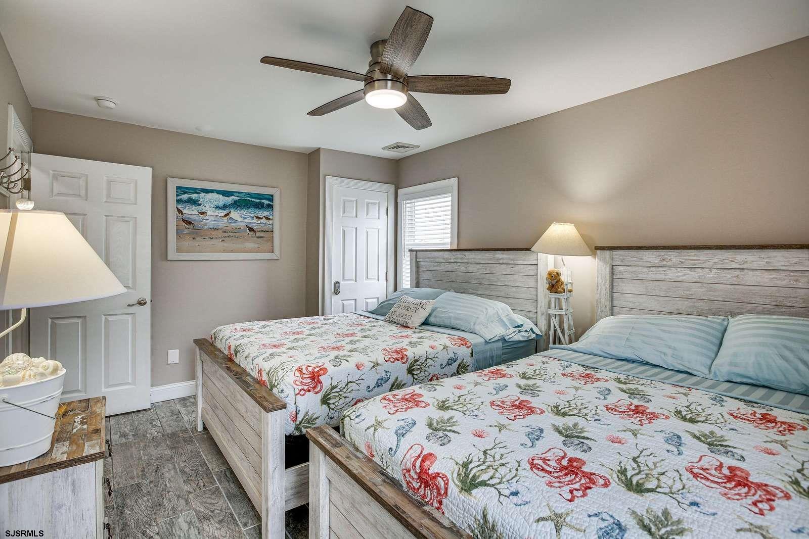 210 34th Street South, Unit 2 Brigantine, NJ 08203 - Photo 10 of 32 a bedroom with two beds and a lamp with window