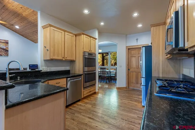 a kitchen with stainless steel appliances granite countertop a refrigerator sink and cabinets