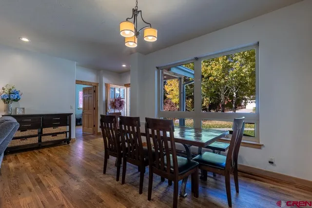 a view of a dining room with furniture window and wooden floor
