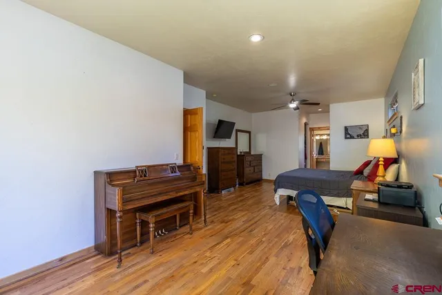 a bedroom with furniture and wooden floor