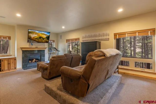 a living room with furniture a fireplace and a flat screen tv