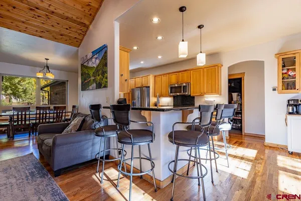 a living room with furniture a rug and a chandelier