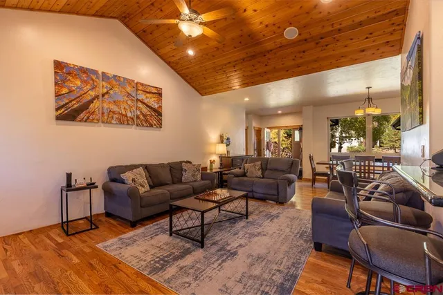 a living room with furniture a rug and a chandelier