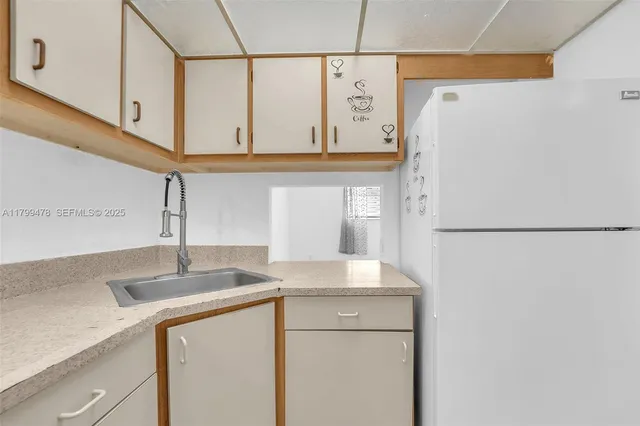 a kitchen with a sink and a refrigerator