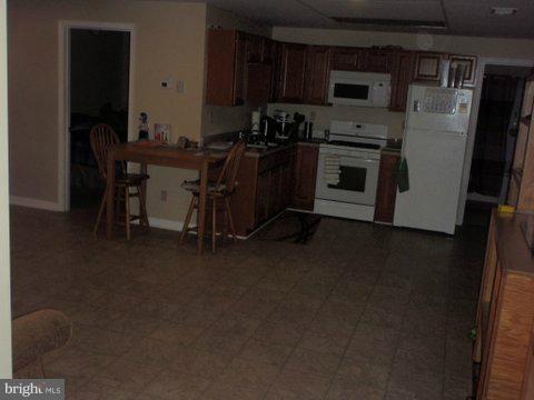 5169 Courtneys Corner Road Sumerduck, VA 22742 - Photo 29 of 29 a kitchen with stainless steel appliances a stove a sink a refrigerator and a dining table