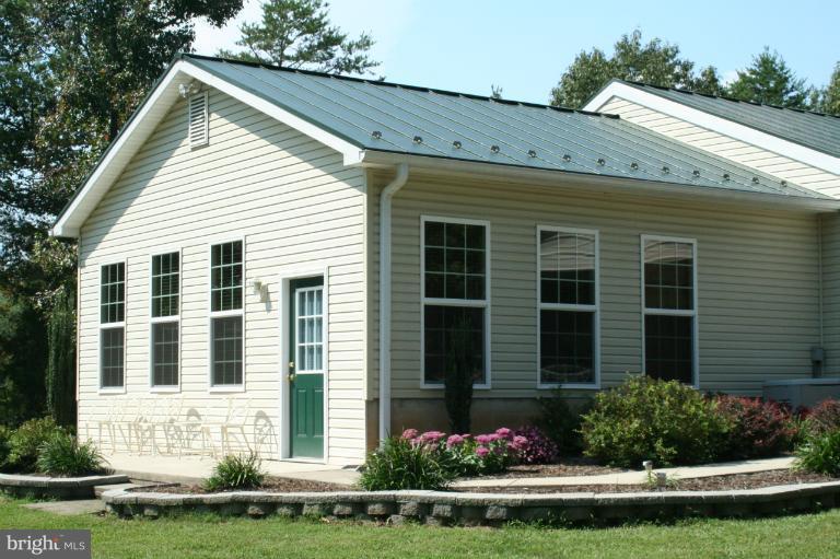 5169 Courtneys Corner Road Sumerduck, VA 22742 - Photo 4 of 29 a front view of a house with a yard and potted plants