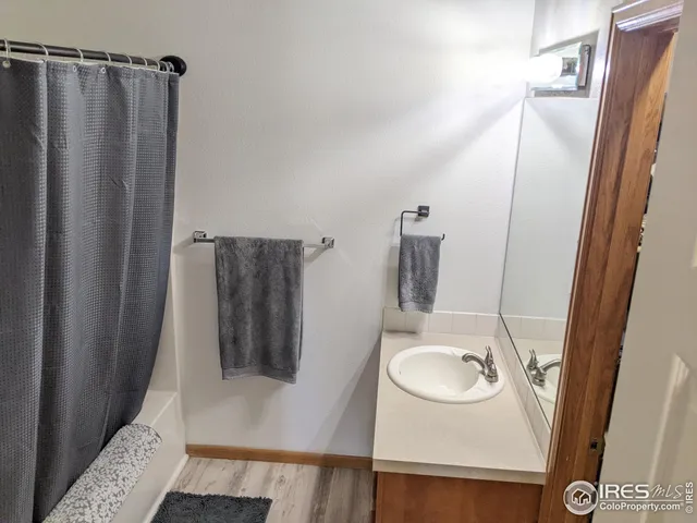 a bathroom with a sink a mirror and shower