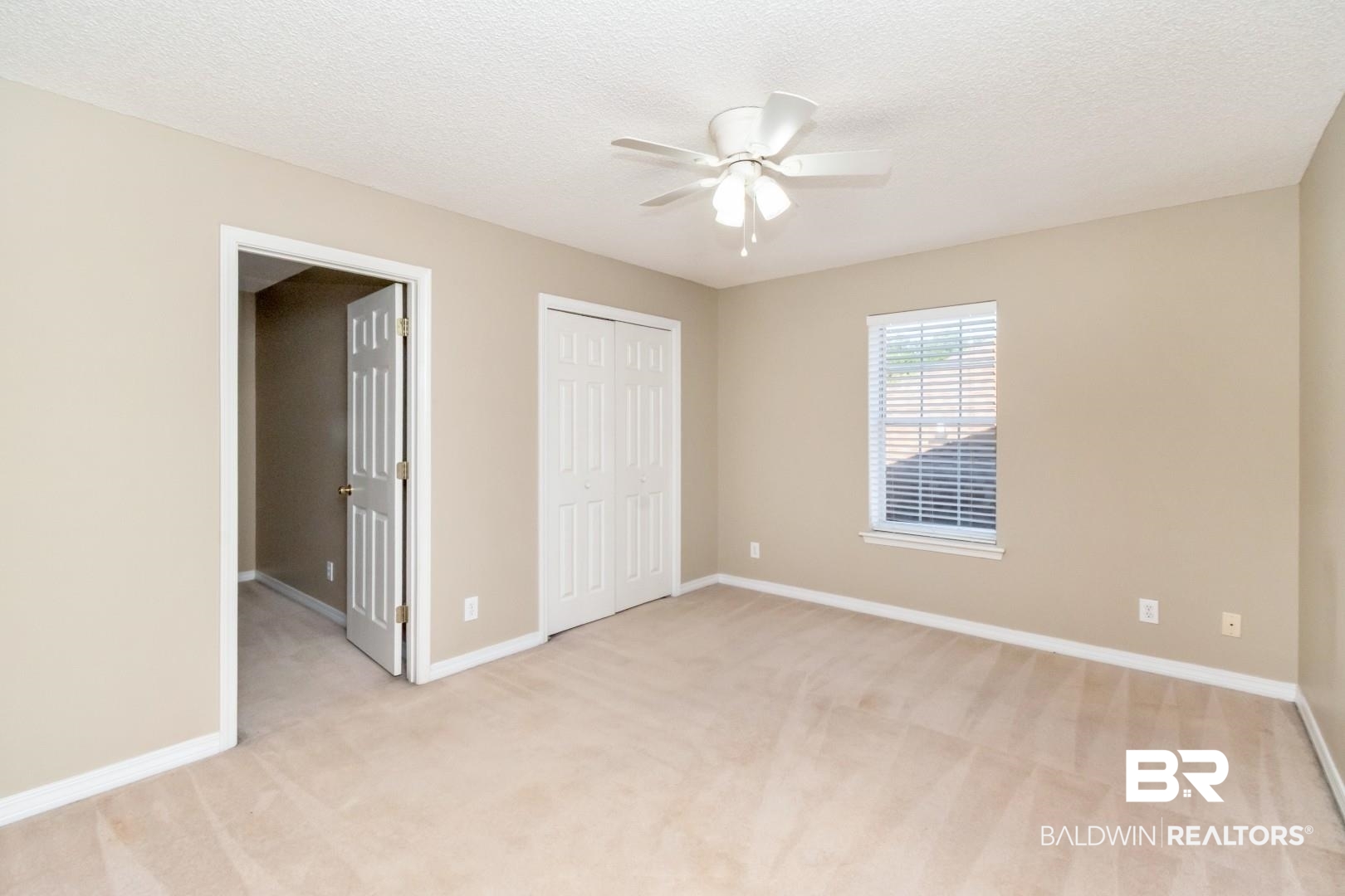 6482 Cedar Bend Court Mobile, AL 36608 - Photo 18 of 26 Unfurnished bedroom featuring light colored carpet, a textured ceiling, a ceiling fan, and a closet
