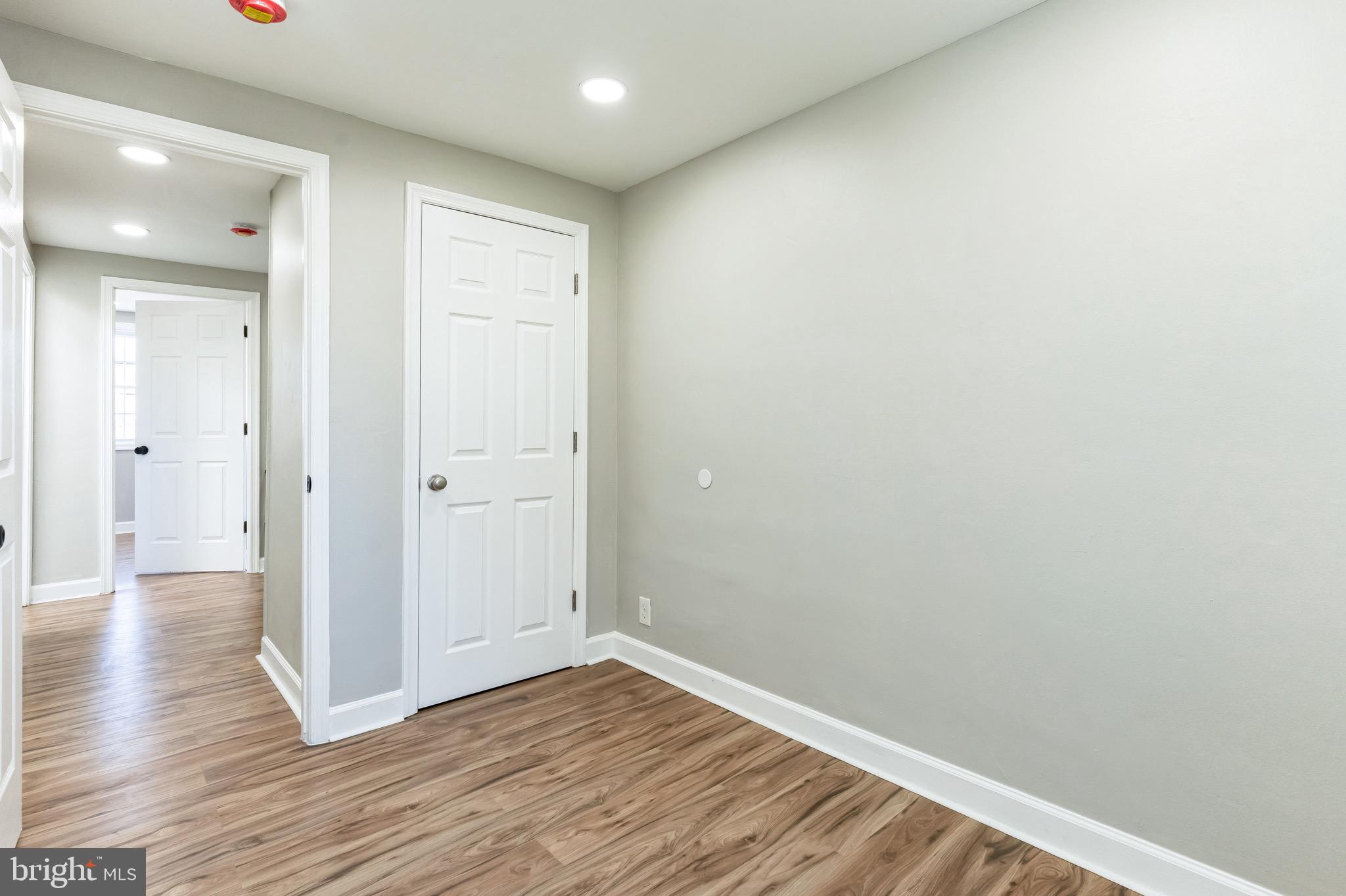 815 Fifth Avenue Baltimore, MD 21227 - Photo 13 of 17 a view of an empty room with wooden floor