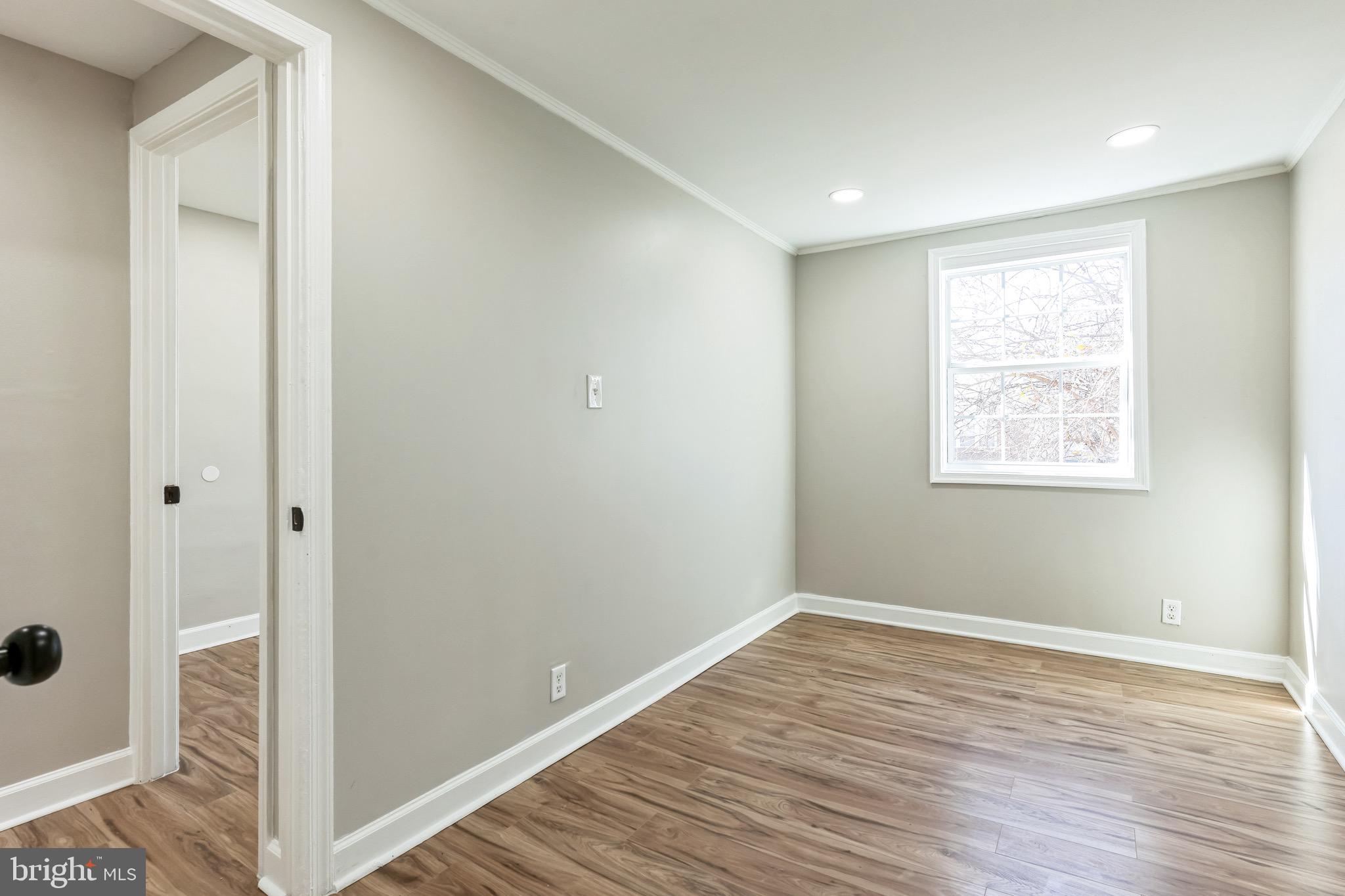 815 Fifth Avenue Baltimore, MD 21227 - Photo 15 of 17 a view of empty room with wooden floor
