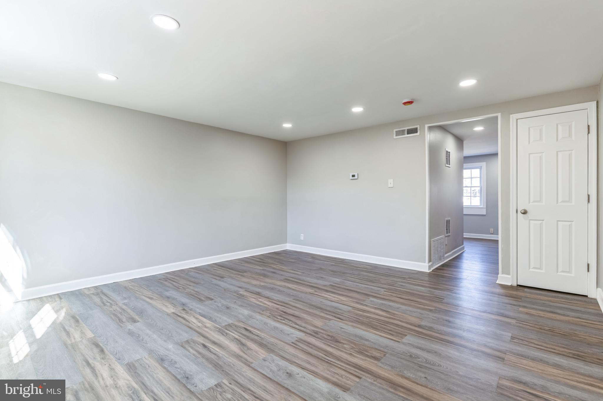 815 Fifth Avenue Baltimore, MD 21227 - Photo 6 of 17 a view of an empty room with wooden floor