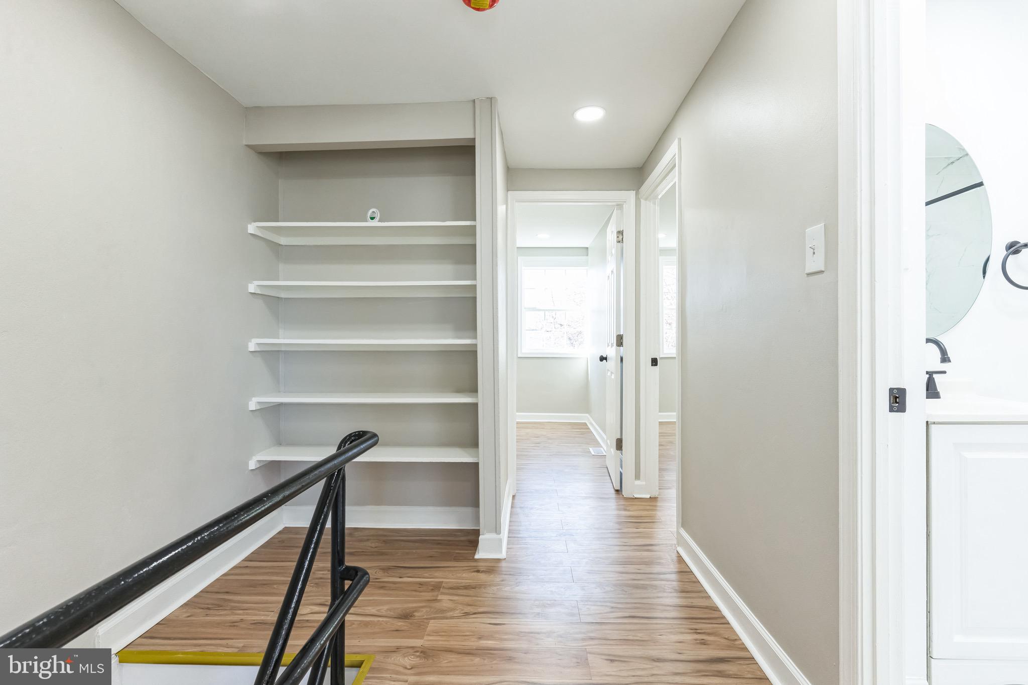 815 Fifth Avenue Baltimore, MD 21227 - Photo 8 of 17 a view of a hallway with wooden floor and staircase