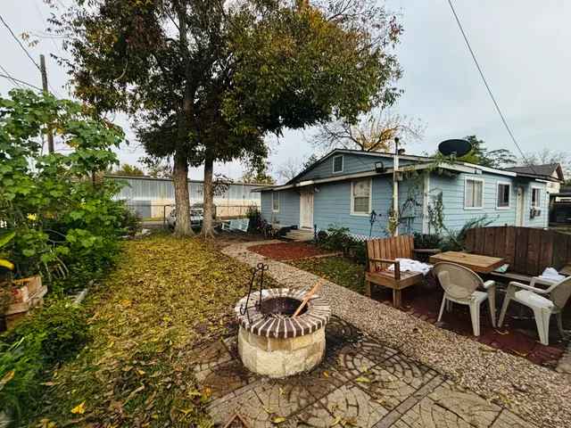 a view of a patio with table and chairs and potted plants