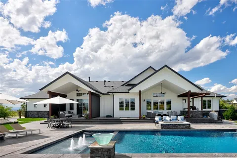 a view of a house with sitting area and a yard