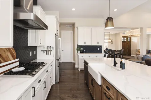 a kitchen with stainless steel appliances a sink stove and cabinets